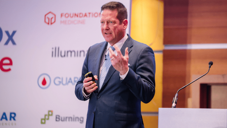 Industry experts presenting on stage at a construction cybersecurity conference