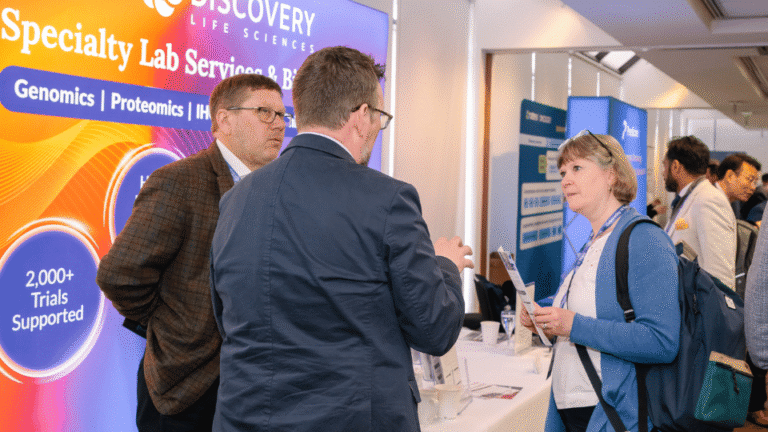 Sponsor representatives speaking with conference attendees