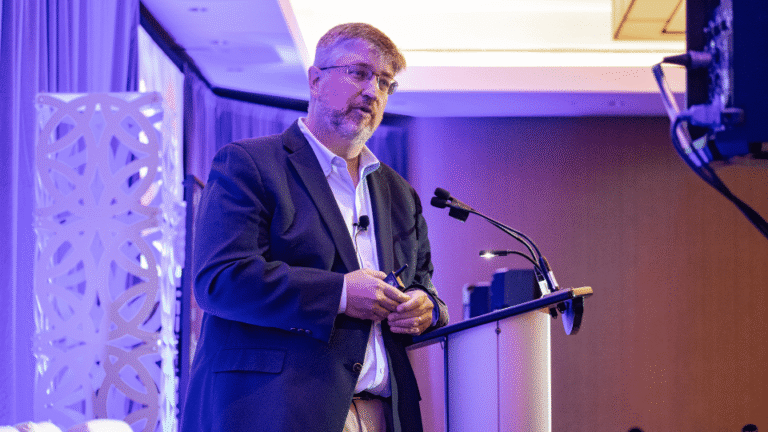 Speaker delivering a keynote presentation on stage